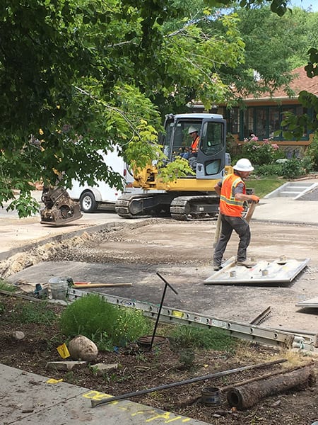 Stott Plumbing employees begin work on replacing the clay sewer line.